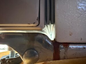 Appliance door hinge bracket with worn plastic bushing and screws