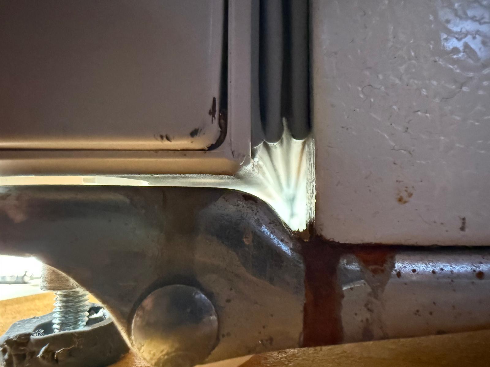 Appliance door hinge bracket with worn plastic bushing and screws