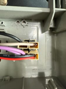 Close-up of appliance wire connector block with plugged-in leads