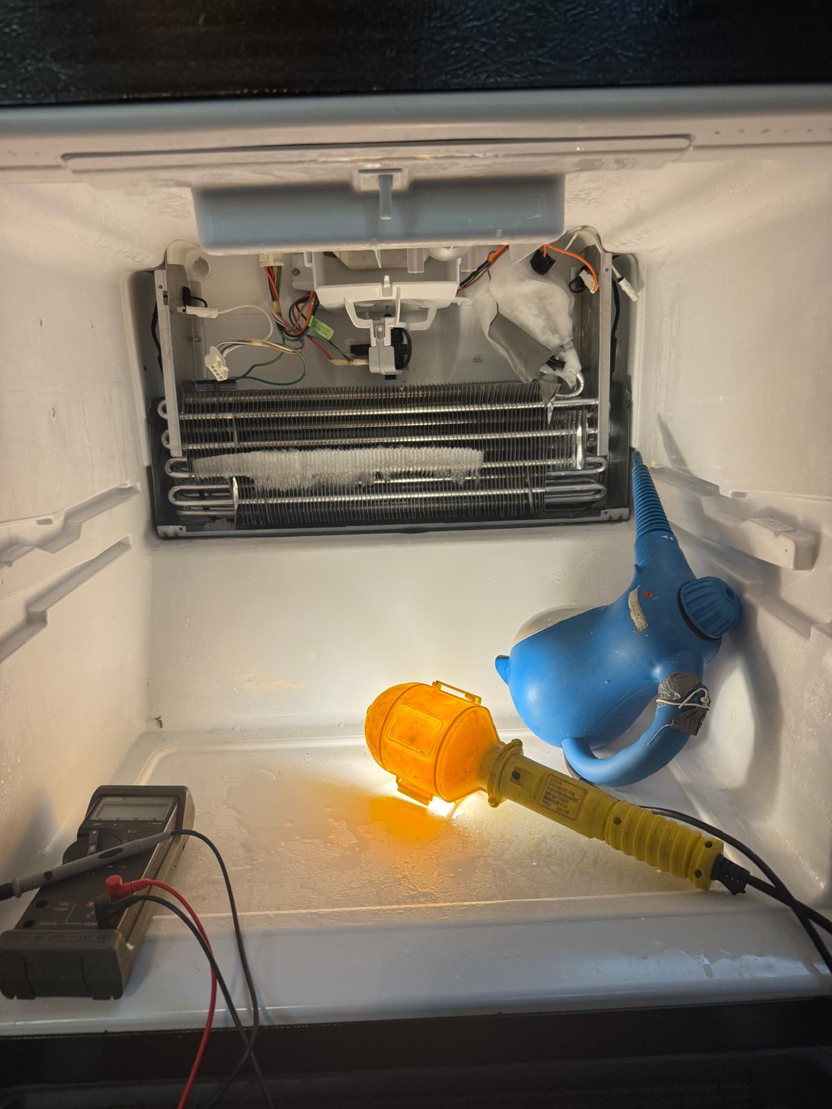 Freezer evaporator area during defrost repair and cleaning